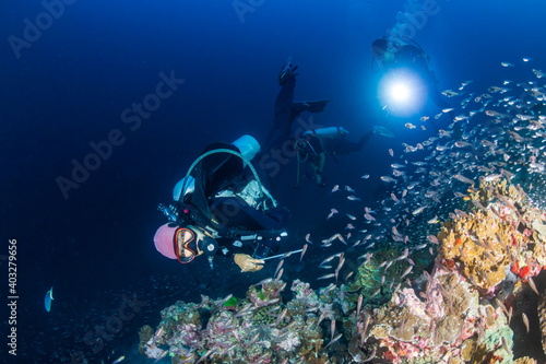 Female SCUBA diver on a tropical coral reef in Thailand