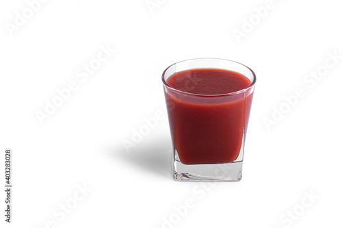 Tomato juice in glass on a white background. View from the top.