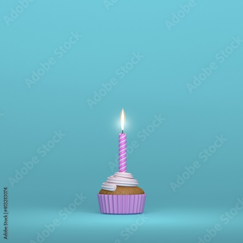 A birthday candle lighting on a creamy muffin cupcake on a blue background and pink colors and space for text