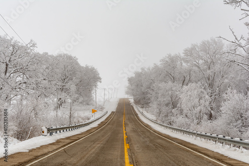 Illinois Rt 178 surrounded by snow and ice on a cold and foggy winters day.