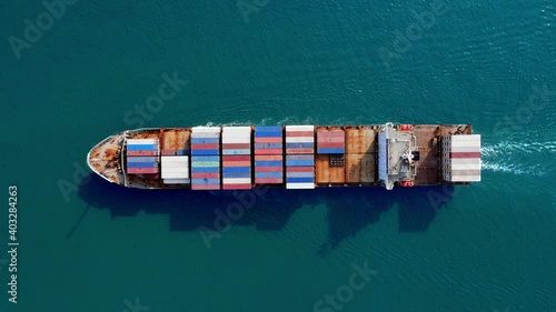 big cargo ship in center of blue ocean