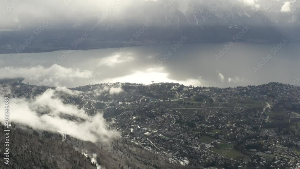 Drone Aerial of the swiss town of Montreux. The winter has just begun in Switzerland and beuatiful snowy mountains reveal the historic city center located on the lake geneva (lac leman). Drone Aerial of the swiss town of Montreux. The winter has just begun in Switzerland and beuatiful snowy mountains reveal the historic city center located on the lake geneva (lac leman).