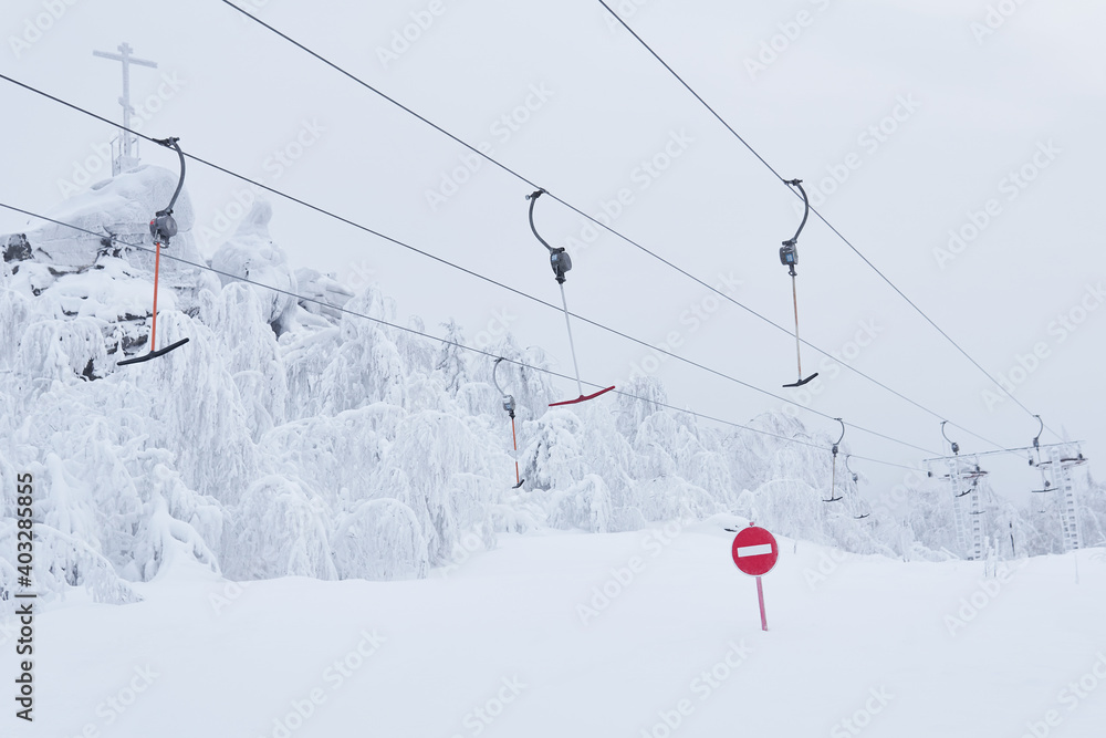 prohibitory road sign No entry against the background of an empty ski surface lifts on a snowy ski slope prohibitory road sign No entry against the background of an empty ski surface lifts on a snowy ski slope