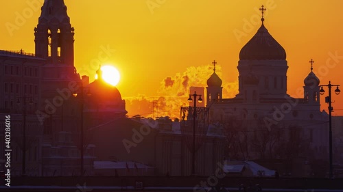 Sun setting over the city with The Cathedral of Christ the Savior on a background in Moscow, Russia
