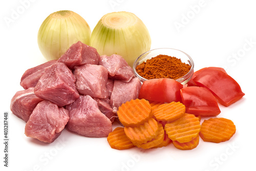 Raw pork pieces, ingredients for goulash, isolated on white background
