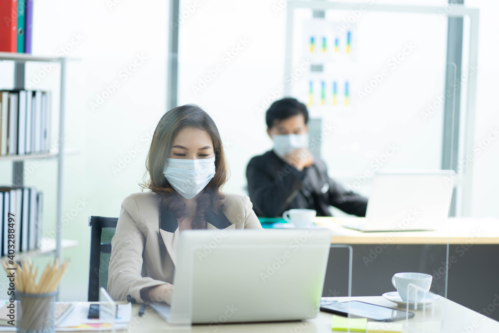 Asian business woman with colleague male in new normal social distancing office with colleague Asian business woman with colleague male in new normal social distancing office with colleague