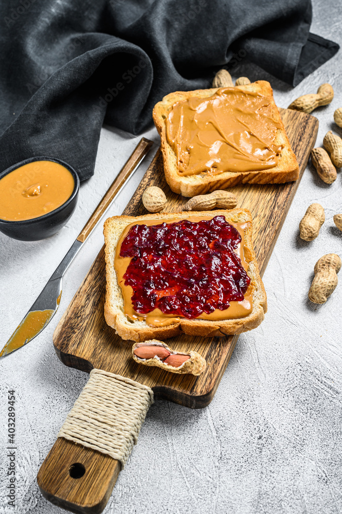 Peanut butter sandwich  toast with berry jam.  White background. Top view