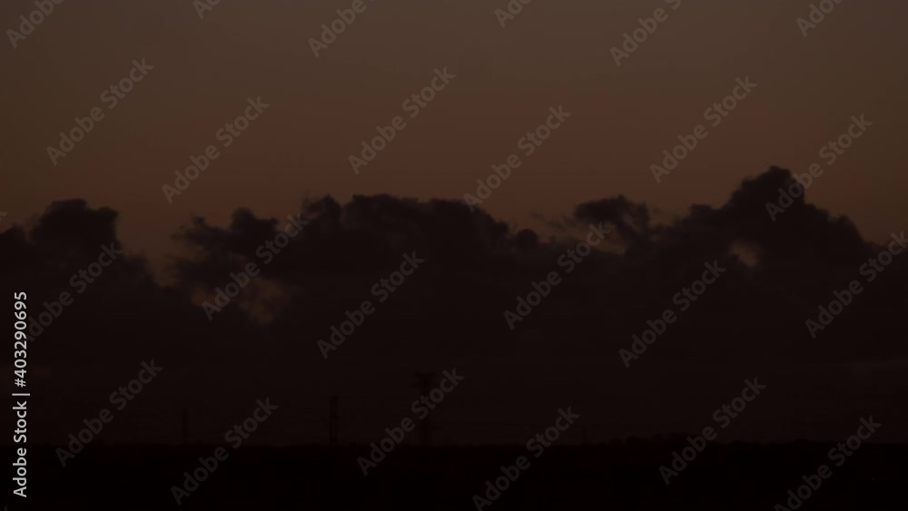 Time lapse shot of fast moving silhouette of cloudscape after sunset on dark sky in the evening. Time lapse shot of fast moving silhouette of cloudscape after sunset on dark sky in the evening.