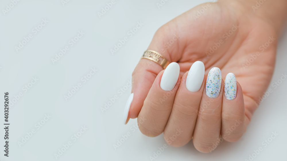 Delicate light manicure with sequins, for a wedding or holiday. Delicate light manicure with sequins, for a wedding or holiday.