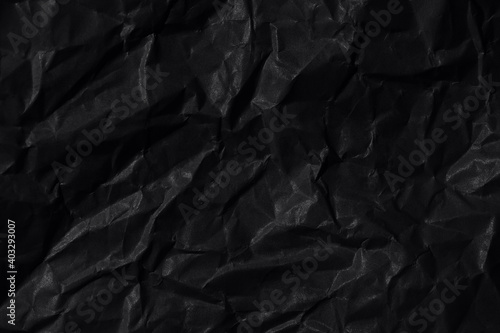 Black background. A crumpled sheet of black paper.