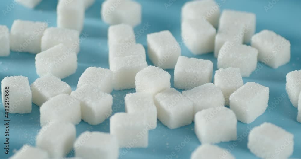 Sugar cubes on the table. On a blue background. Sugar cubes on the table. On a blue background.