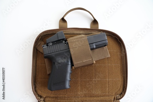 Isolated pistol in a soft carrying case on a white background. No logo's. 9 mm handgun.