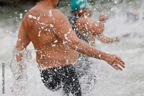 Water splash detail with intentional selective shalow depth of field focus. Concept of healthy lifestyle adventure outdoor swimming activity on beach 