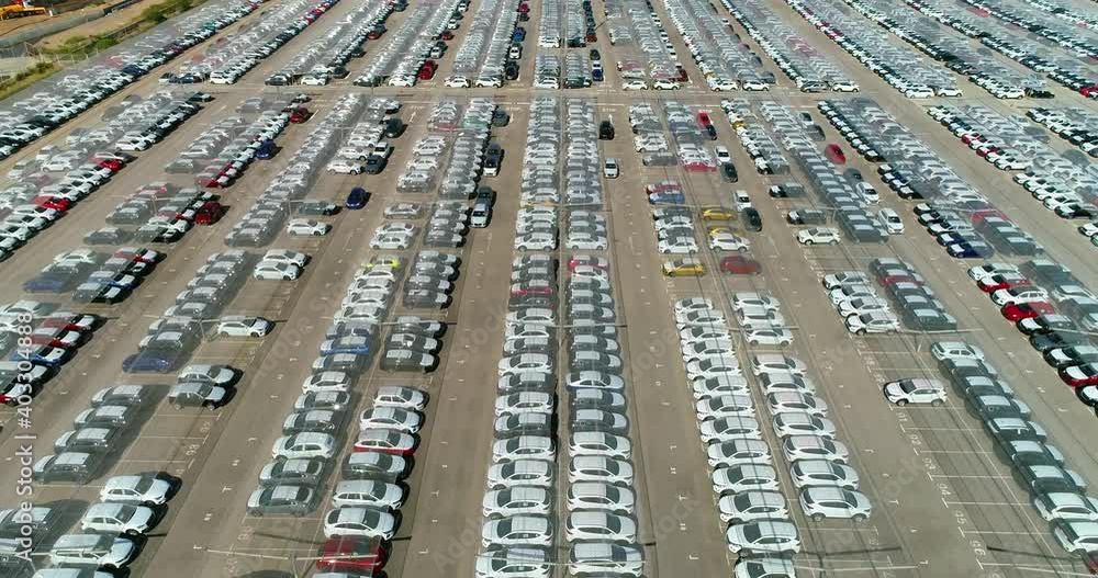 Panoramic view with a drone above a large number of cars parked in a parking lot. They are protected by a transparent plastic roof 4K Panoramic view with a drone above a large number of cars parked in a parking lot. They are protected by a transparent plastic roof 4K