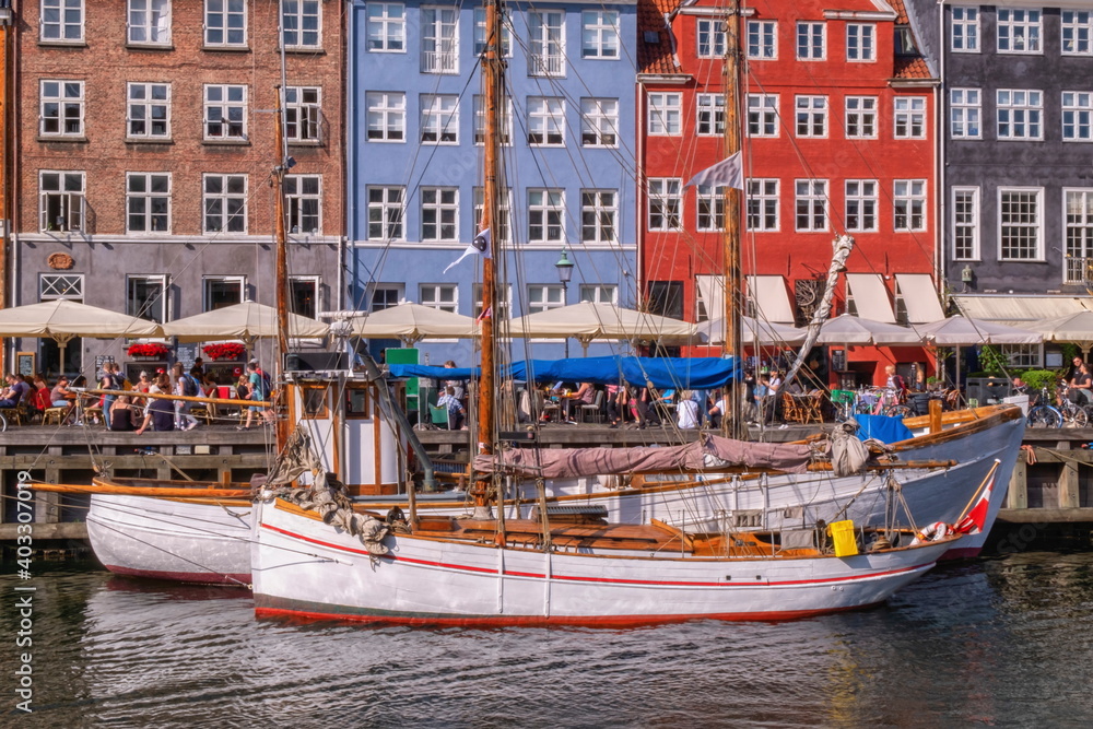 Scenic summer view of color buildings and boats of Nyhavn in Copenhagen, Denmark