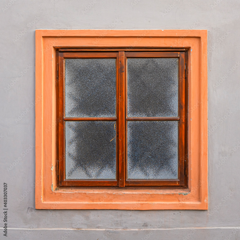 Pink and brown framed window on a wall in the old town of Prague Pink and brown framed window on a wall in the old town of Prague