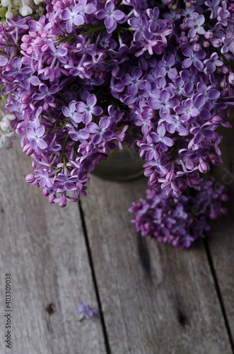 Closeup Purple lilac flowers on a old wooden surface. Spring holidays background.