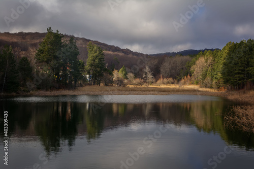 Landscape view of trees with its reflection in the lake. Sliven, Bulgaria