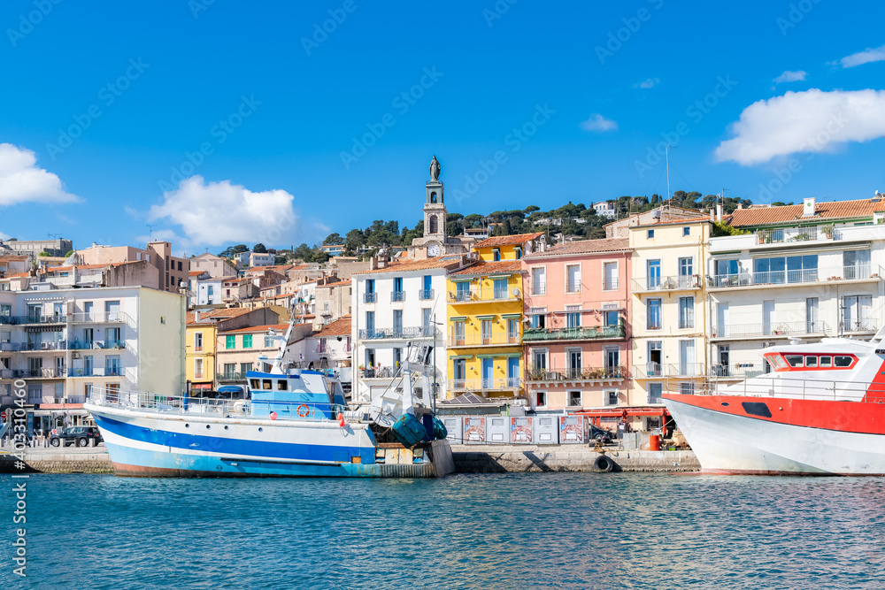 Sète in France, fisherboat at the quay, typical colorful facades
