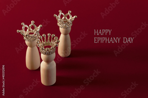 Billede på lærred Three wise men figures with crowns on red background and the text Happy Epiphany day
