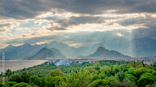 Panoramic bird view over Antalya modern part of the city  Mediterranean seacoast and direct beam lights coming from clouds with amazing rays  Antalya  Turkey.
