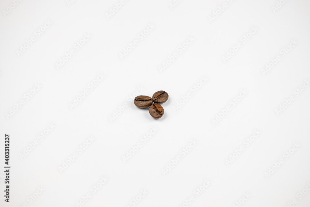 three coffee beans on a white background three coffee beans on a white background