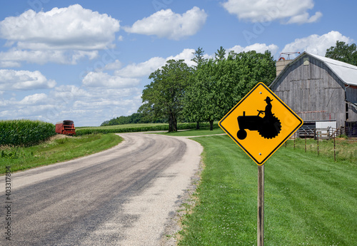 Obraz na plátně Farm Equipment Caution Sign:  A sign in southern Wisconsin alerts motorists to watch for farm machinery on the road ahead