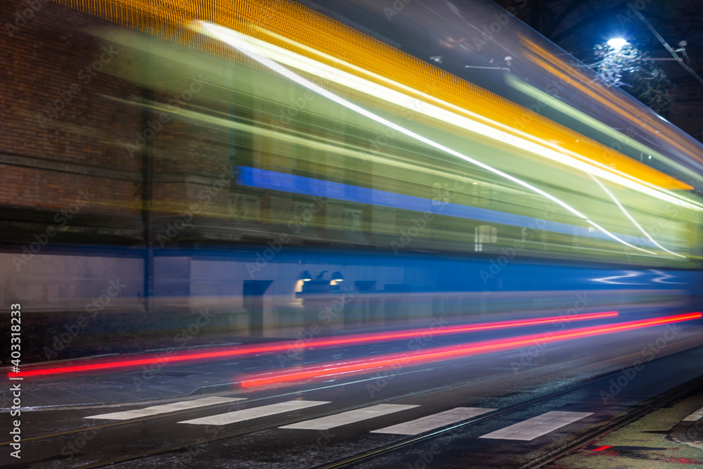 Fast-moving tram at the dark Oslo street. 