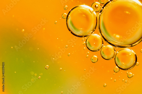 oil drops on water on an orange background