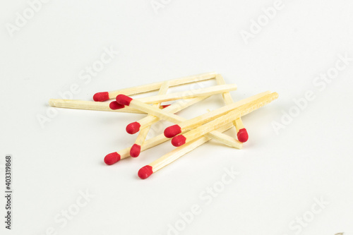 matchsticks with red sparks on a white background