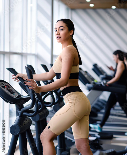 Beautiful young athletic woman in sportswear doing fitness exercises in the gym. Healthy lifestyle concept
