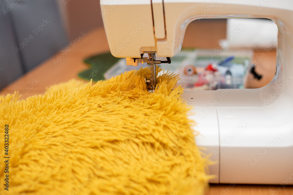 sew fur on sewing machine. close-up photo