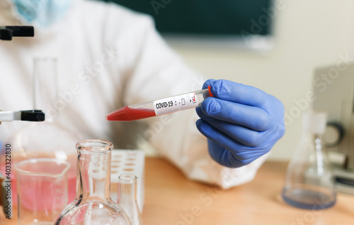 Chemist in the laboratory of coronavirus research in vitro shooting covid-19 close-up photo