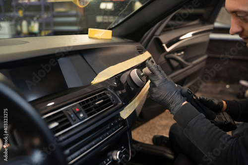 Professional polishing car interior trim. Auto detailing concept © Andrii 