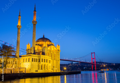 Ortakoy Mosque in night lights, in the background the bridge over the Bosphorus, Istanbul, Turkey