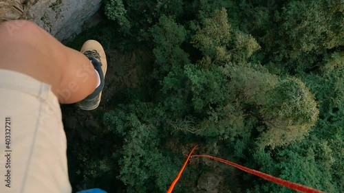 guy do rappelling looking down photo