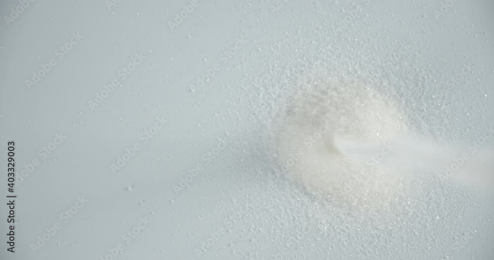 Sugar slowly pours into a heap. Sugar slowly pours into a heap.