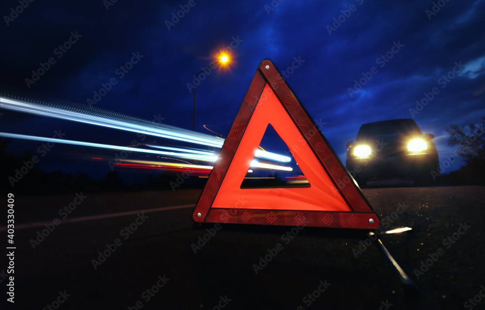 Red emergency stop sign (red triangle warning sign) with long-exposure ...