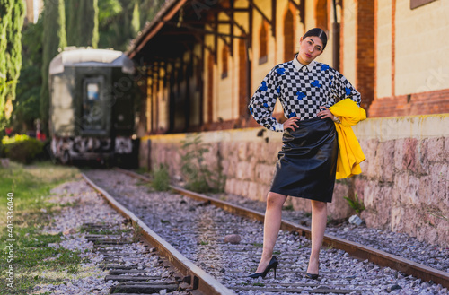 Young girl in vintage clothes at old train station