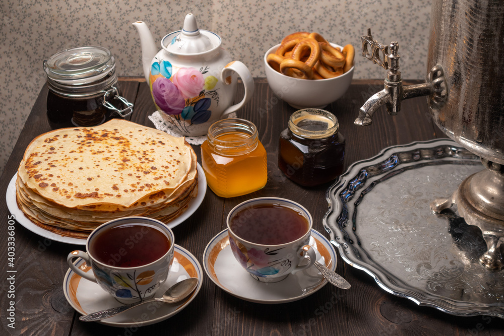 Tea party with samovar, crepes, bagels, honey, jam Tea party with samovar, crepes, bagels, honey, jam