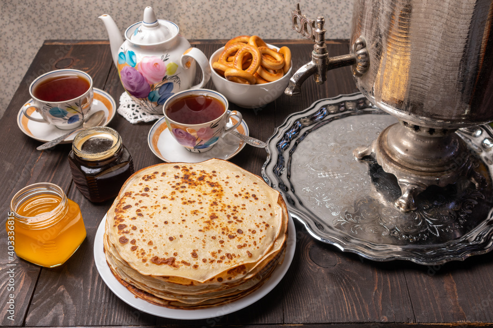 Tea party with samovar, crepes, bagels, honey, jam Tea party with samovar, crepes, bagels, honey, jam