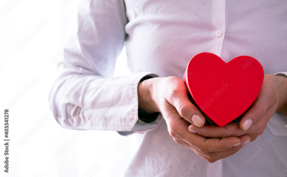 Woman holding red heart in hands, closeup. Red heart. Love concept. Photo. Sensual. Woman holding red heart in hands, closeup. Red heart. Love concept. Photo. Sensual.