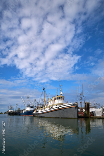 Steveston Harbour Fishboats in Sunshine. Commercial fishboats in the harbor of Steveston  British Columbia  Canada near Vancouver. Steveston is a small fishing village on the banks of the Fraser Rive 