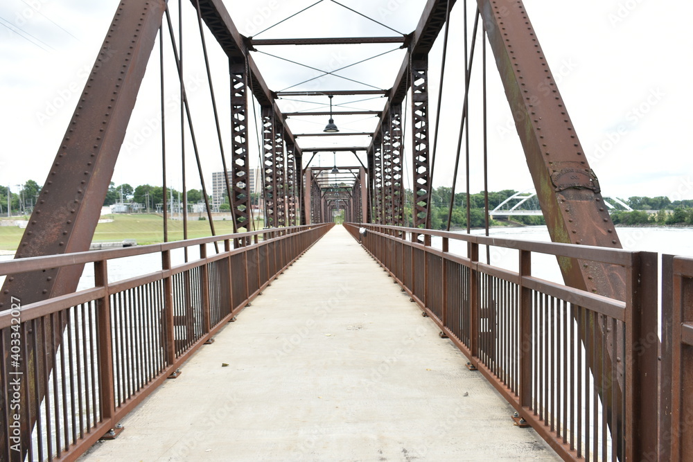 A bridge path leading over a river along the dam