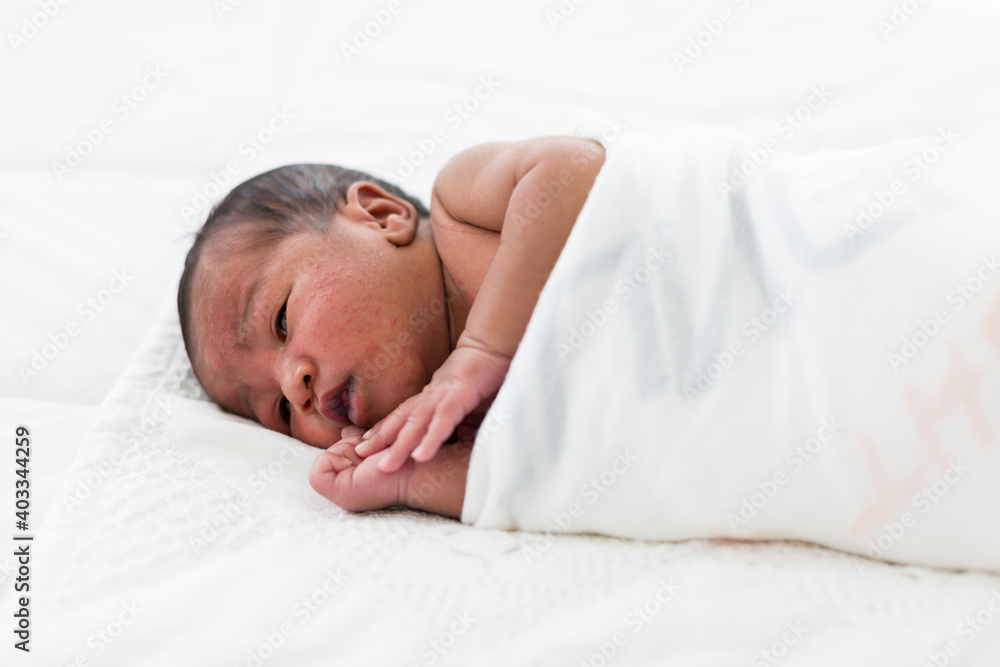 Newborn baby or Infant lying in blanket on white bed. African American newborn baby. Afro infant Newborn baby or Infant lying in blanket on white bed. African American newborn baby. Afro infant