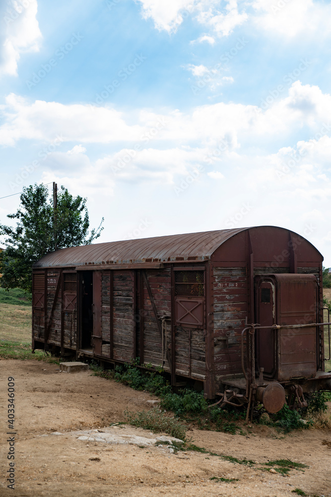 An Old Train Wooden Wagon in the Middle of a Wild West Farm An Old Train Wooden Wagon in the Middle of a Wild West Farm