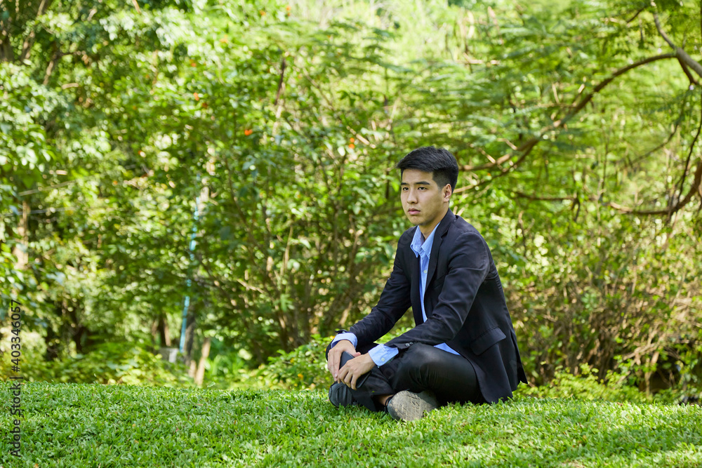 Young businessman relaxing in the garden