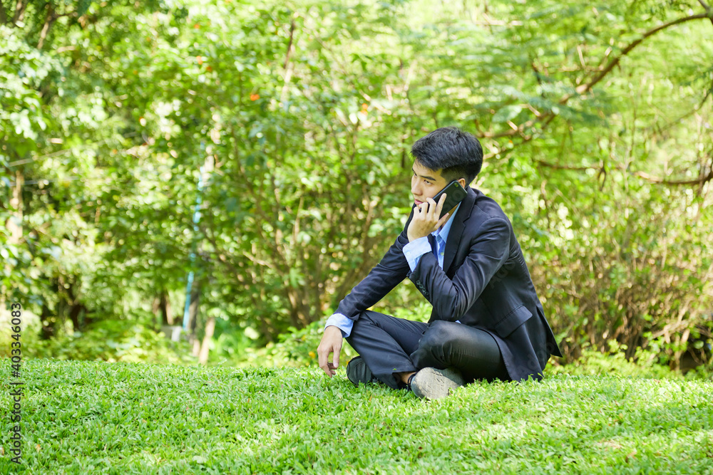 Young businessman relaxing in the garden Young businessman relaxing in the garden