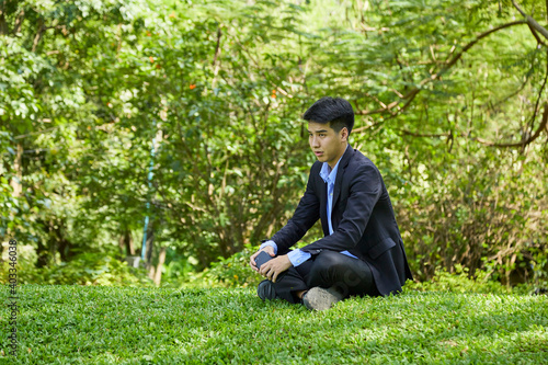 Young businessman relaxing in the garden
