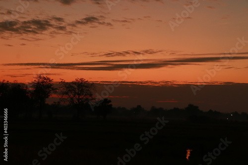 The orange light from sunrise ,silhouette and clouds sky in the morning